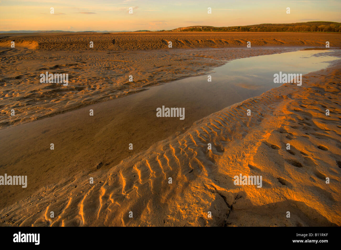 View across the dangerous quicksand mud flats of the Arnside estuary of the river Kent in Lancashire England Stock Photo