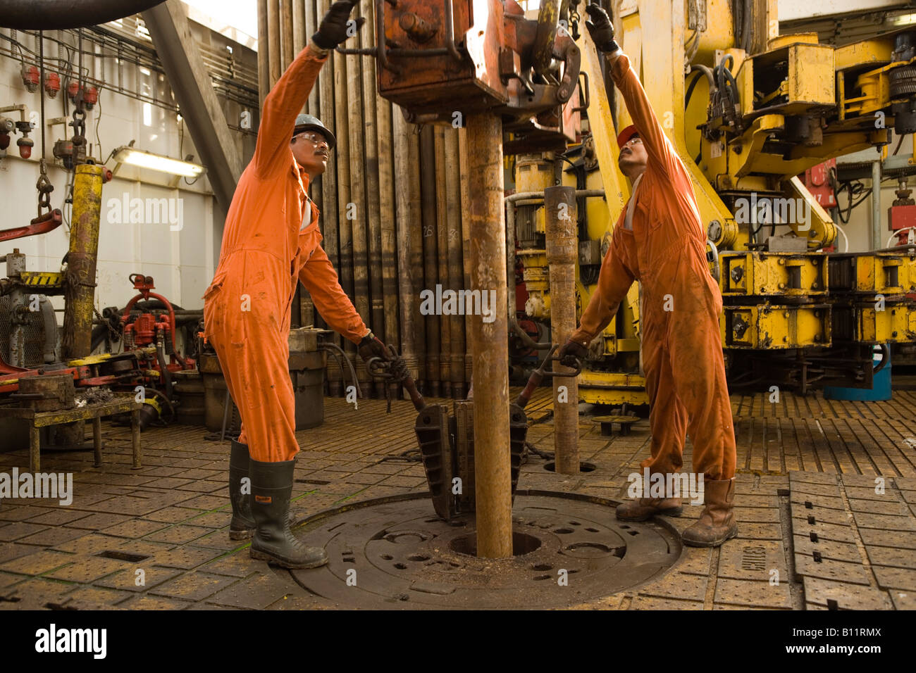 Oil workers on the drill floor. Ensco rig. Natuna Field. Sea South China Sea. Indonesia Stock