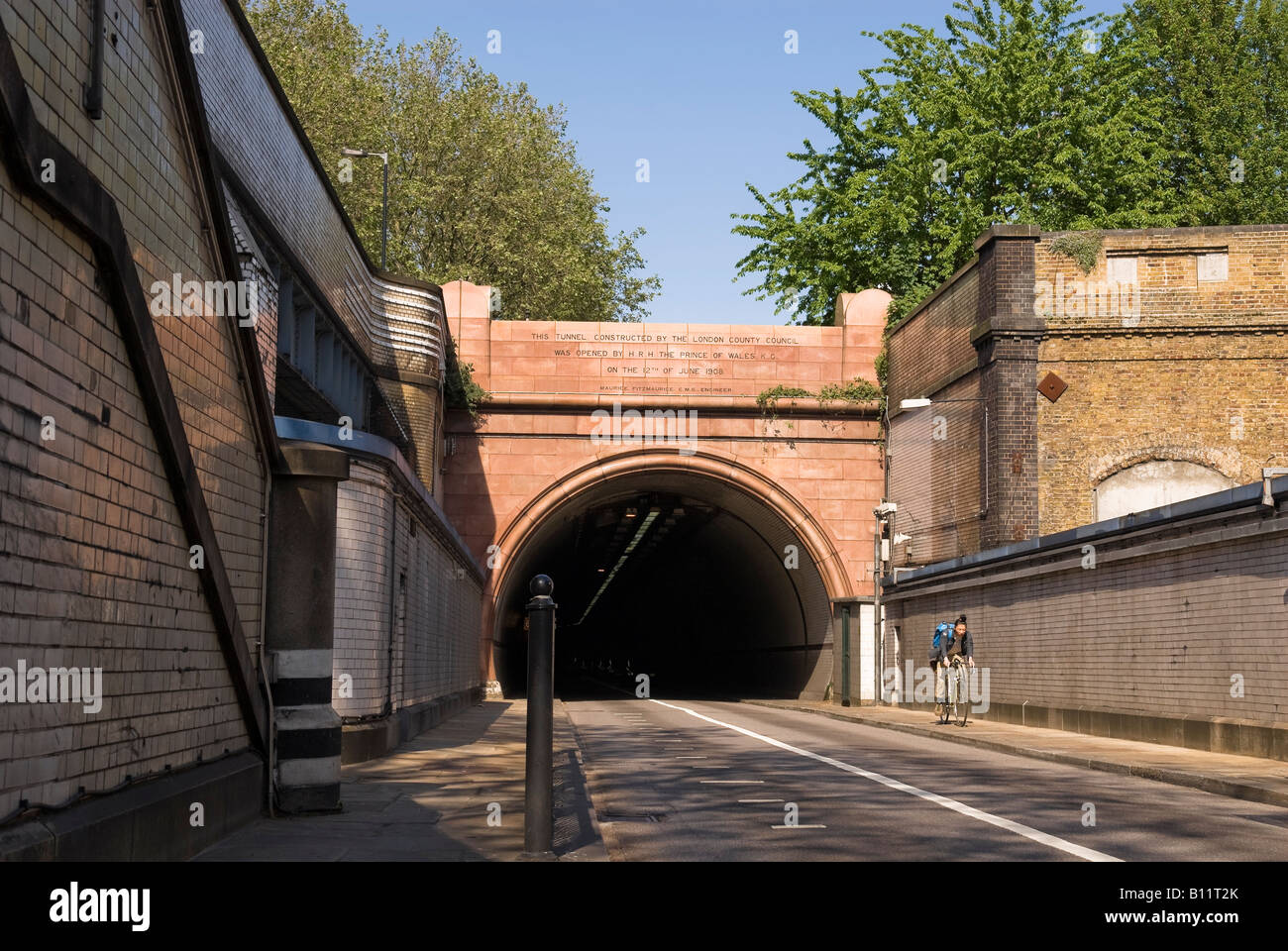 Cyclist coming out of the Surrey side Rotherhithe Road Tunnel, London Stock Photo