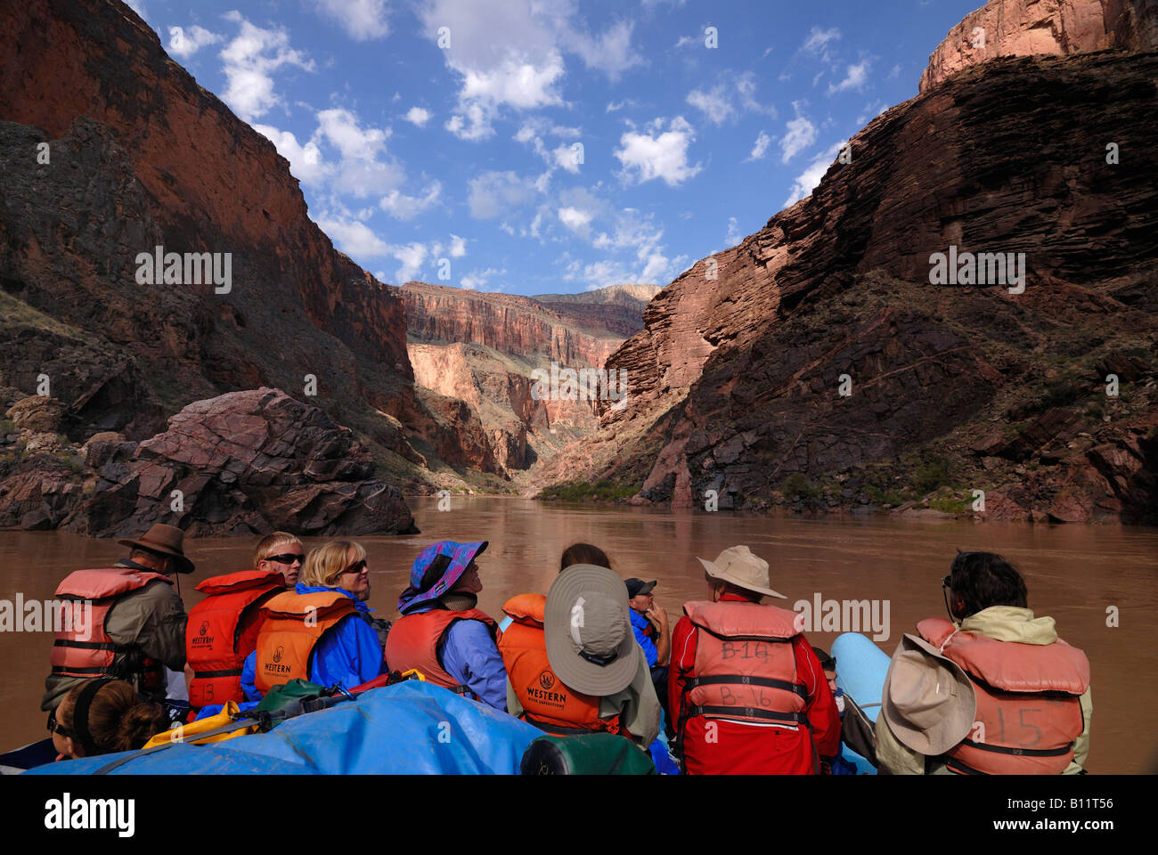 Tourist admiring the stunning scenery of the Grand canyon while rafting down the Colorado river 