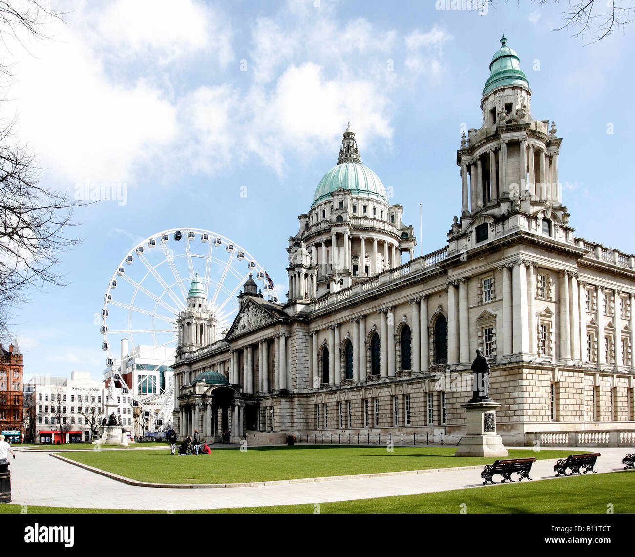 Belfast City Hall with the Belfast eye 200ft talll known as the Wheel of Belfast Each observation journey lasts approximately 12 Stock Photo