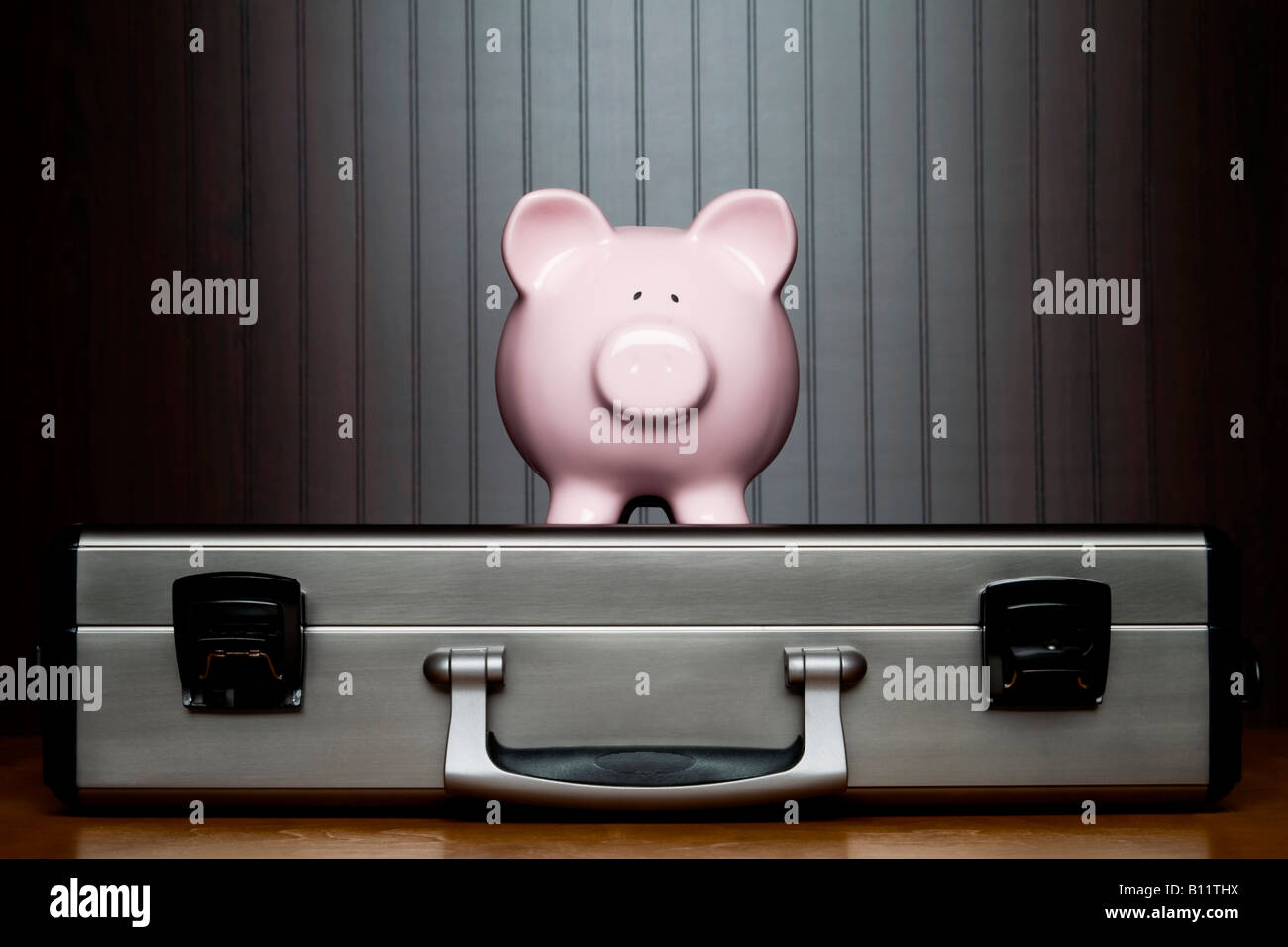 Piggy bank on top of a briefcase Stock Photo