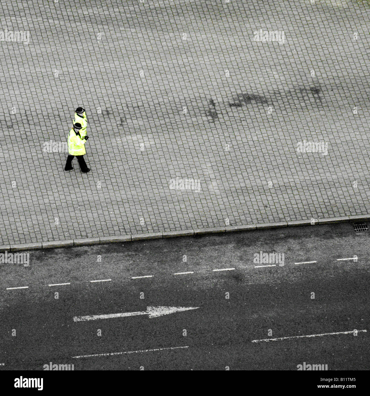 Urban image of two police unidentifiable police officers or pcs officers on the beat in UK Stock Photo
