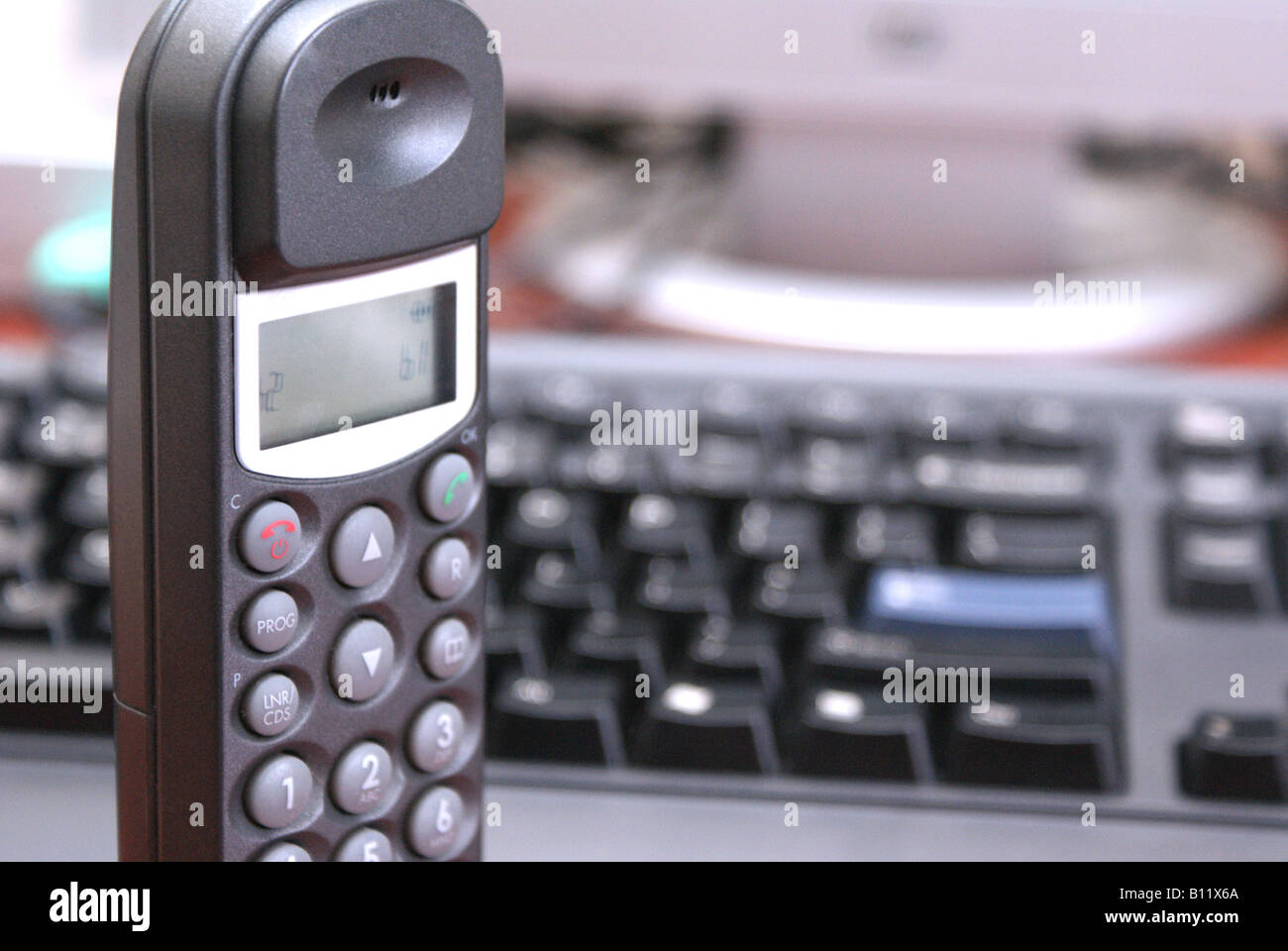 phone in front of pc keyboard Stock Photo Alamy