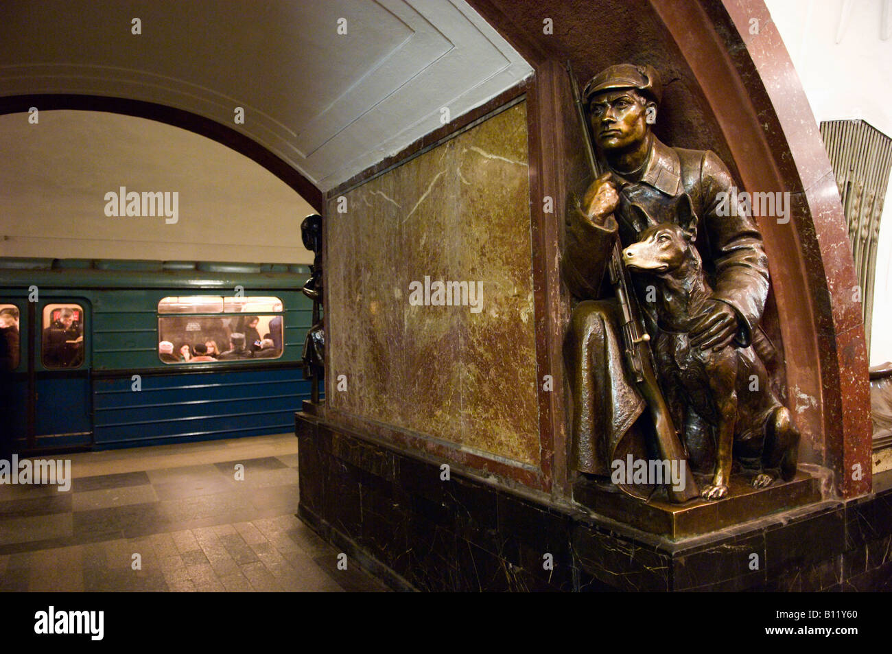 Bronze statue of a border guard with his dog at Revolution Square metro
