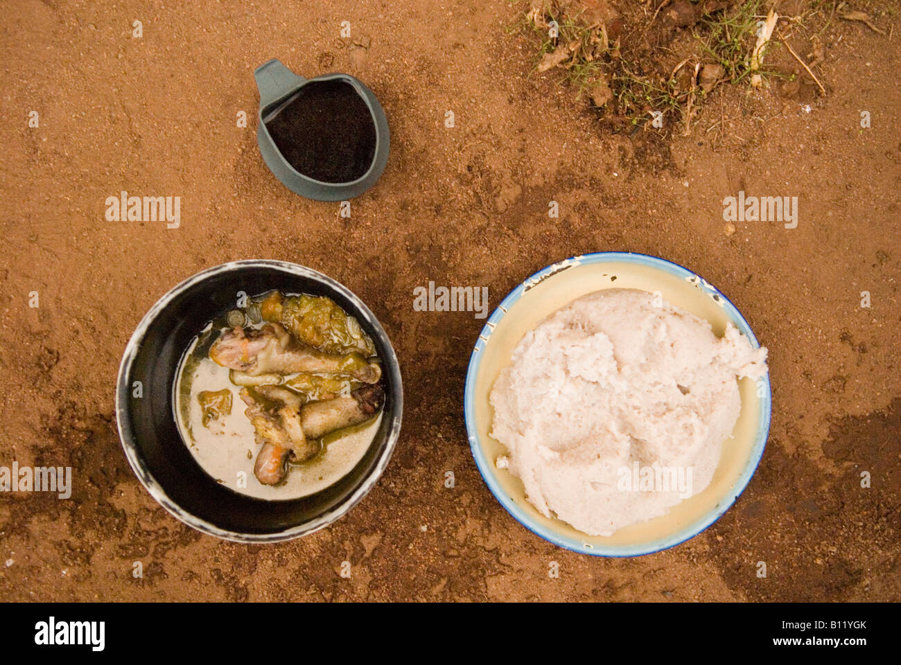 Limited food choice in Niassa Reserve, Mozambique: Xima (Cassava-based staple) and a piece of bony chicken. Stock Photo
