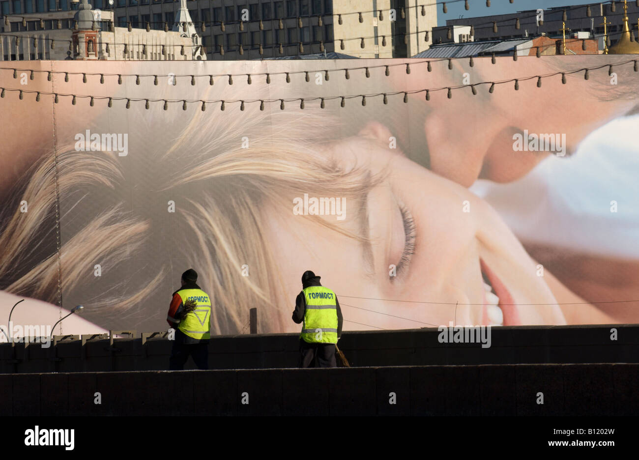 Two Municipal cleaners on the Bolshoy Moskvoretskiy Bridge against an ...