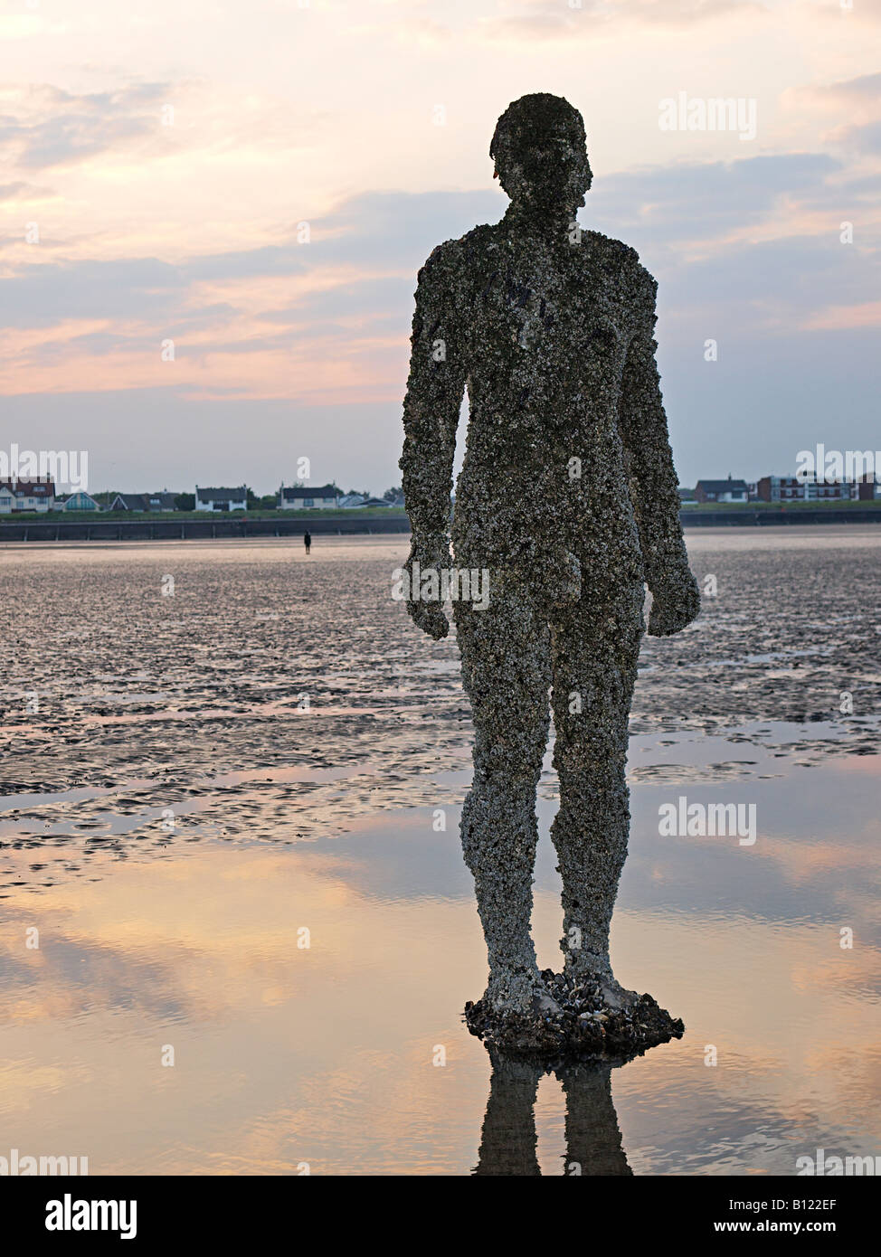 ANTONY GORMLEY SCULPTURED FIGURE ON BEACH AT CROSBY, LIVERPOOL