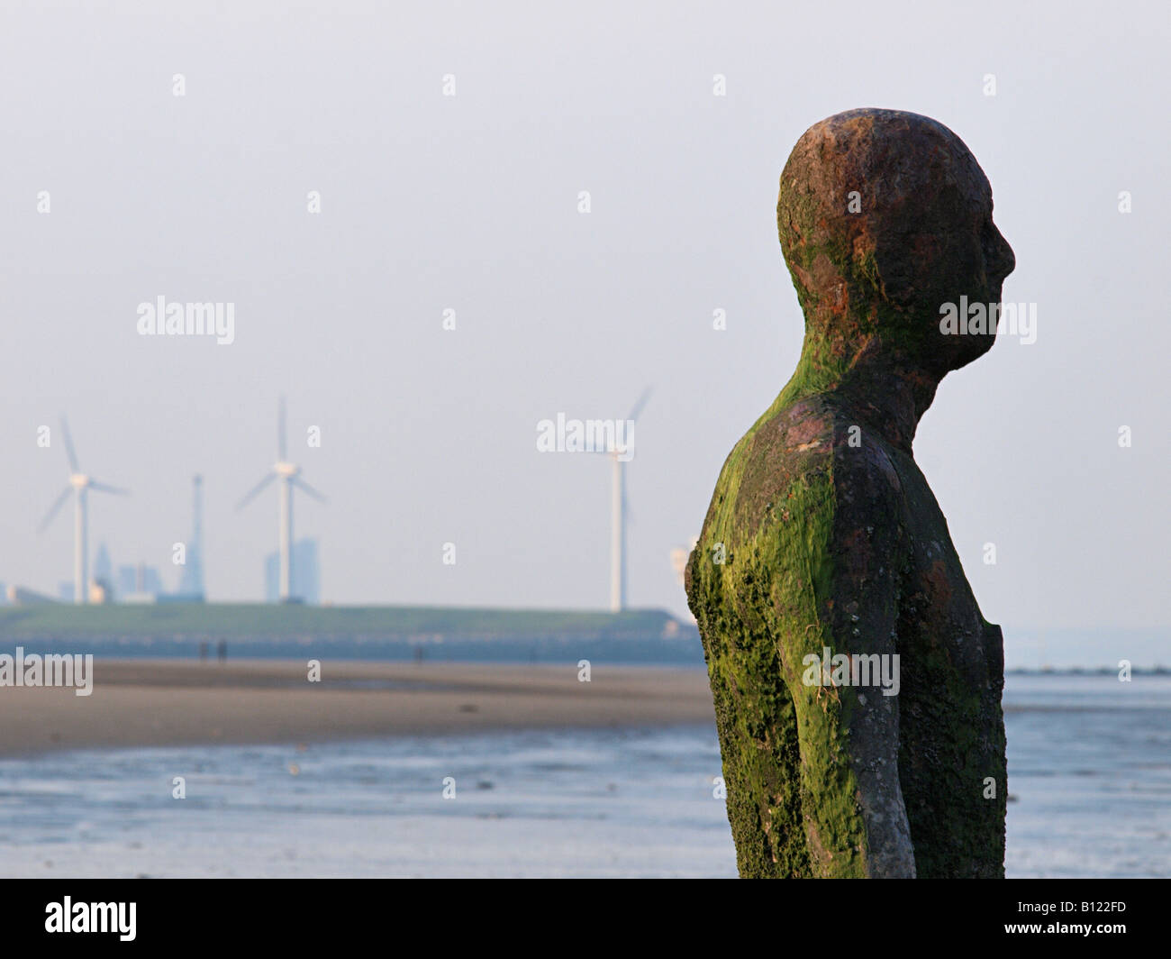 ANTONY GORMLEY SCULPTURED FIGURE ON BEACH AT CROSBY, LIVERPOOL