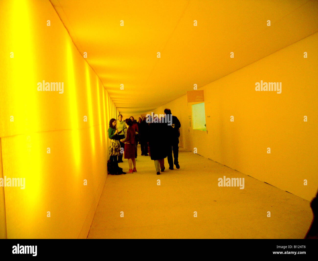 People inside yellow marquee Stock Photo