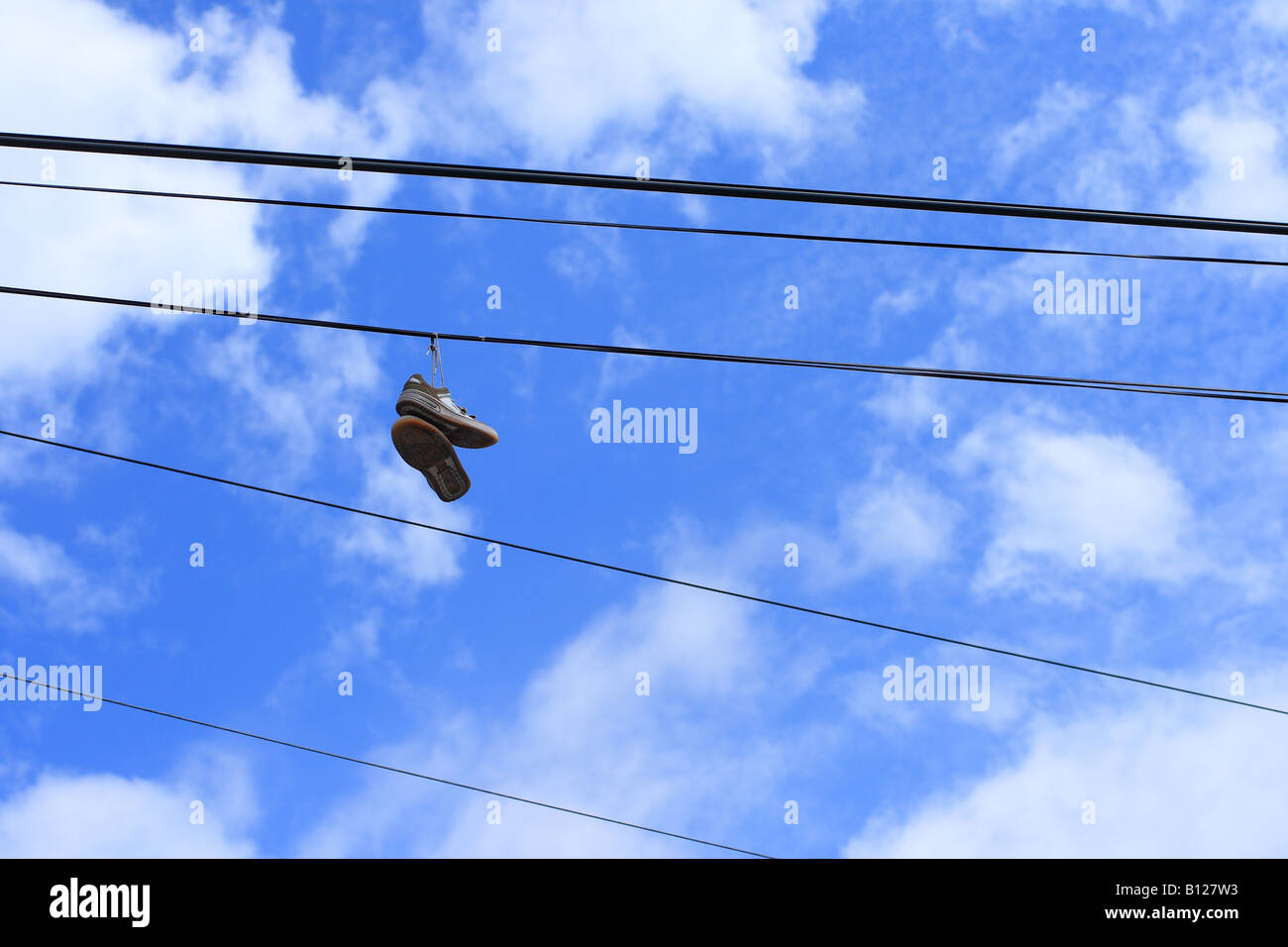 Pair of sneakers hanging from a powerline Stock Photo