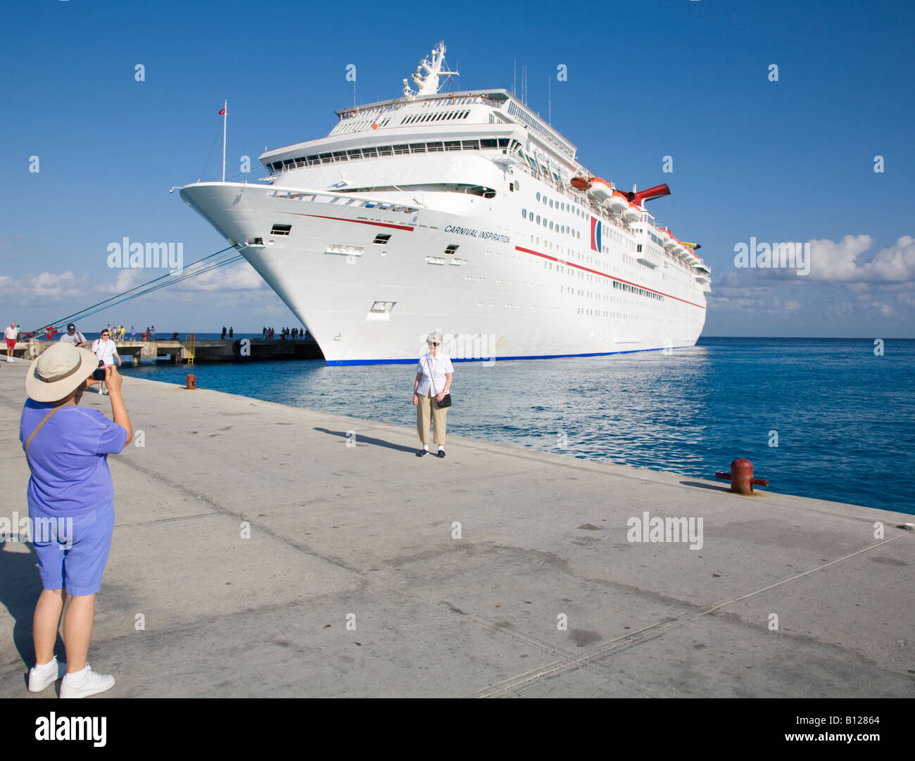 Tourists taking pictures of each other and cruise ship at International Pier in San Miguel on Cozumel Mexico Stock Photo