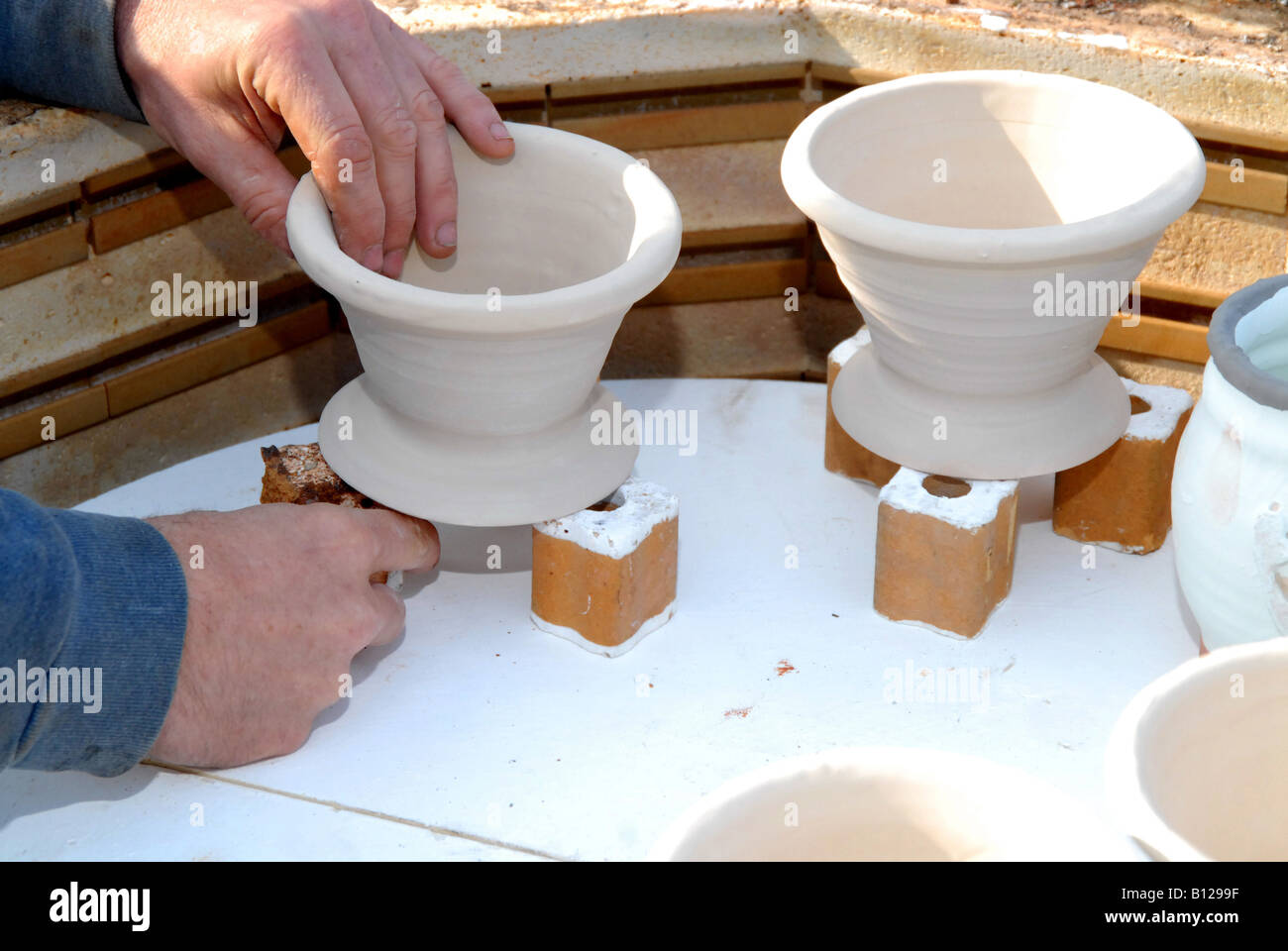A ceramic firing kiln being loaded in preparation for firing Stock