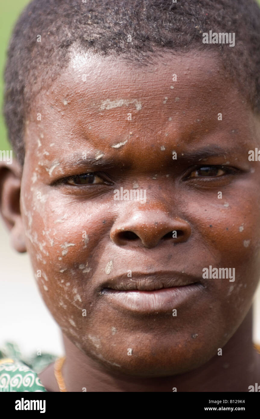 Portrait of Mozambican woman with muddy face from fishing in a muddy
