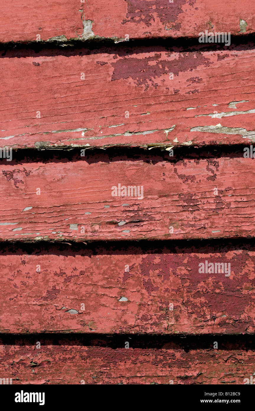 Fading and flaking paint on an old overlapping timber framed boat hull Stock Photo