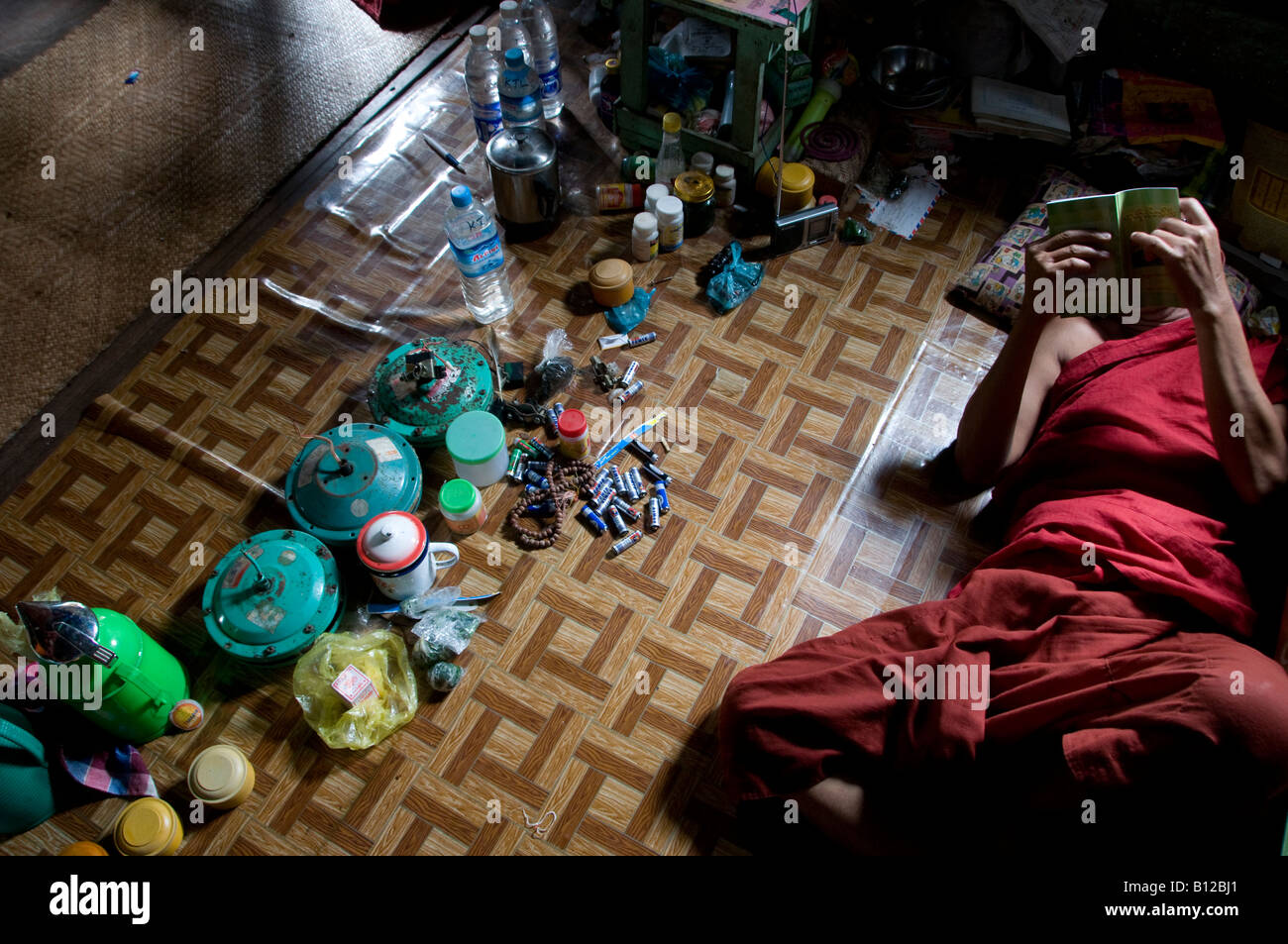 Bhikkhu Buddhist monk reading a book in a monastery in Kyauktan township of Yangon in the Republic of the Union of Myanmar Stock Photo