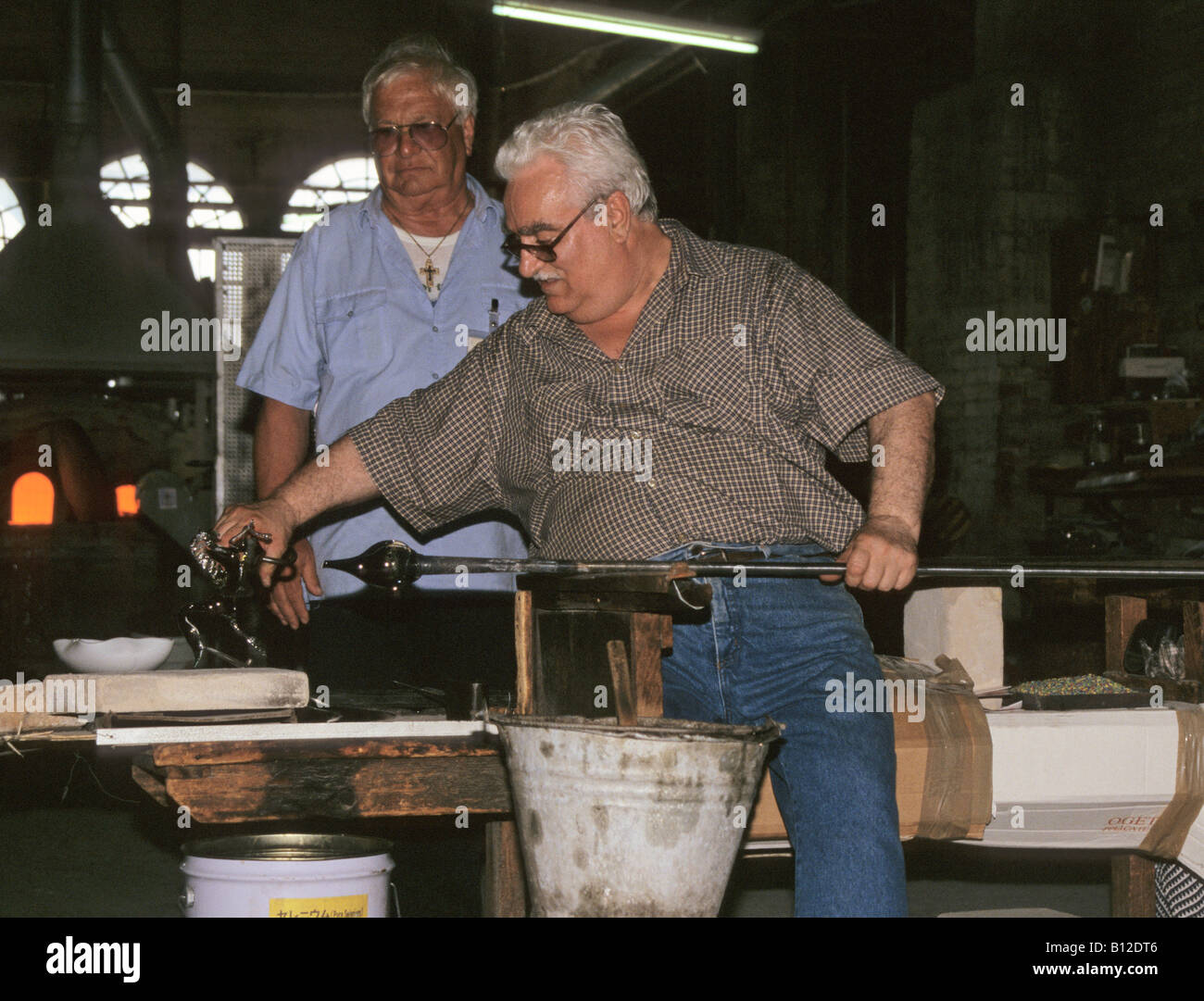 Glassblower in glass blowing factory Murano Island Venice Italy Stock