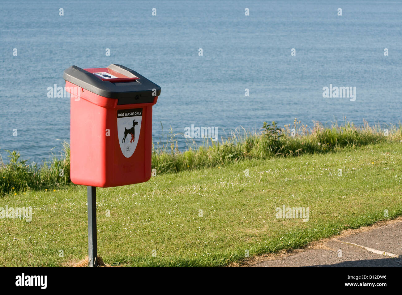 Dog waste bin in a park, by the sea Stock Photo