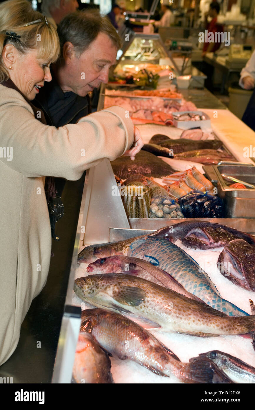 A couple absorbed in shopping at Gothenburg s famous fish market
