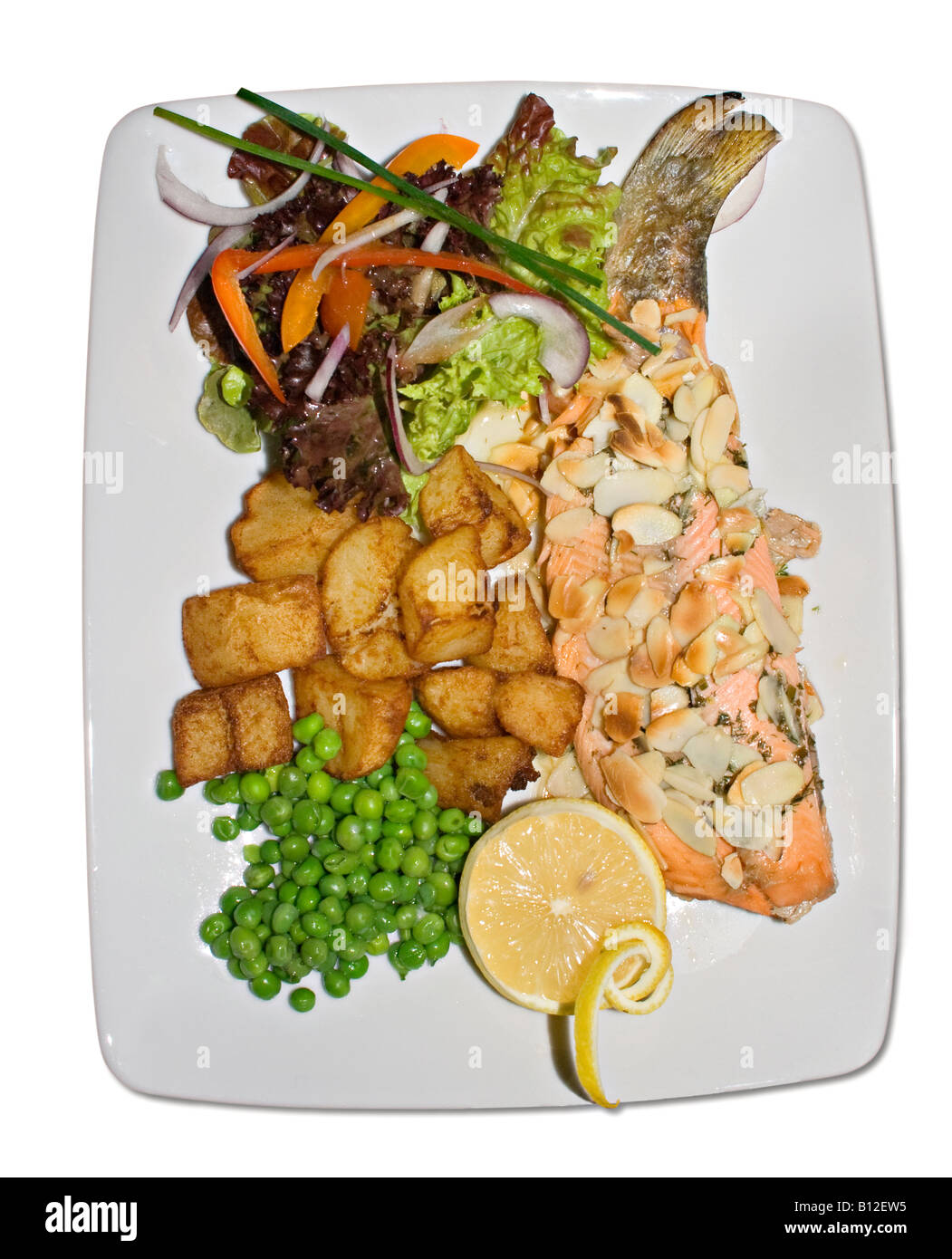 Grilled trout with almonds and vegetables on white plate and white background Stock Photo