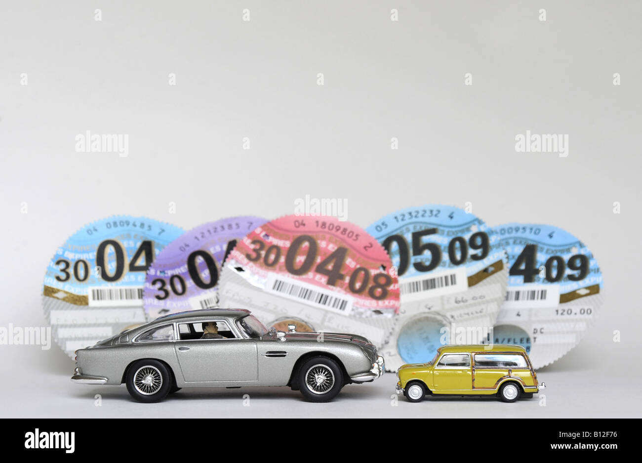 LUXURY LARGE AND ECONOMY SMALL CARS WITH BRITISH TAX DISCS,UK. Stock Photo