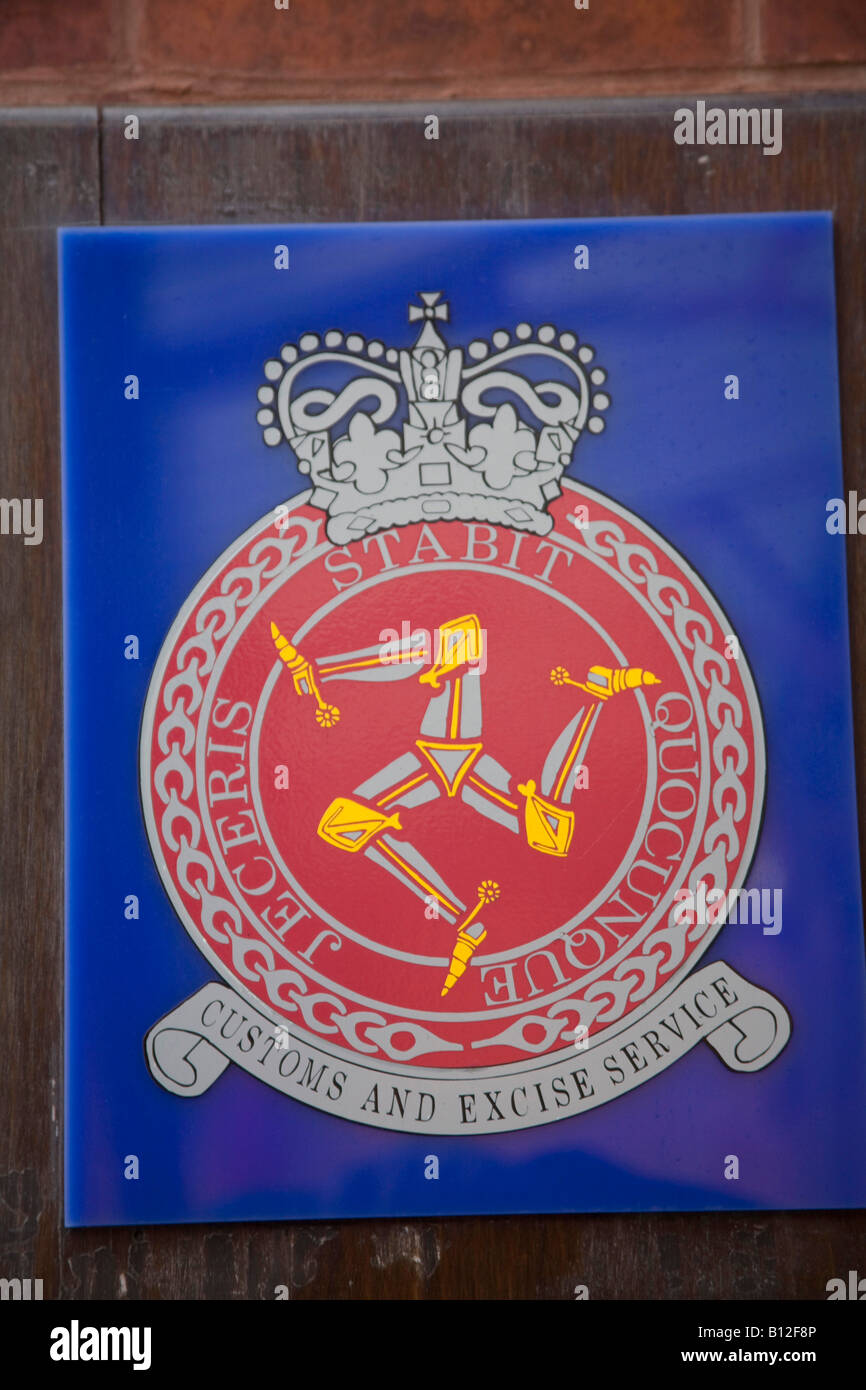 Customs and Excise Service sign. Isle of man logo. Red and Blue. Three Manx legs. Plaque on the wall. 83539 Isle of Man Logo Stock Photo