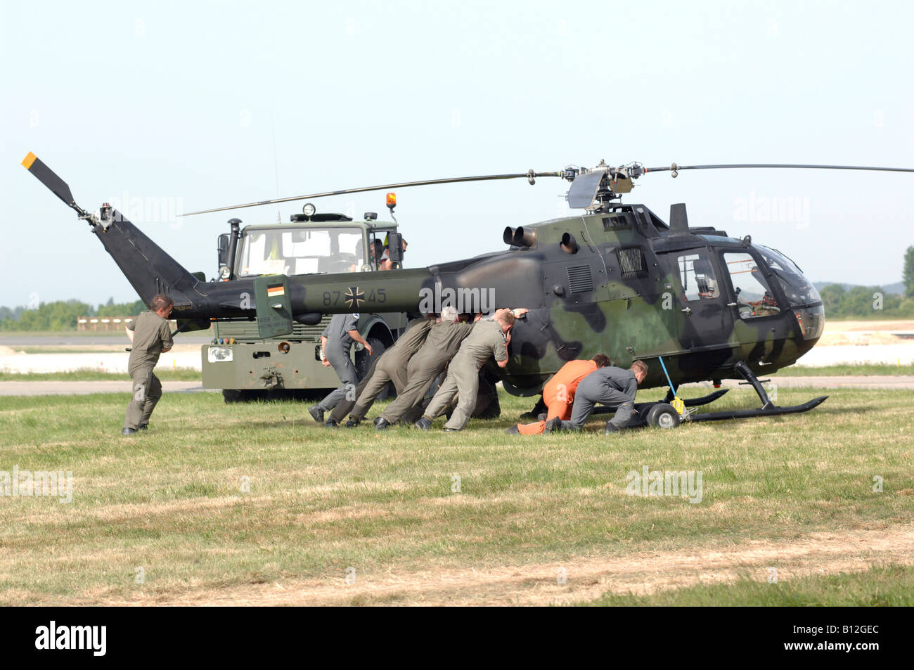 Broke military helicopter of German Bundeswehr removed from field by staff Stock Photo