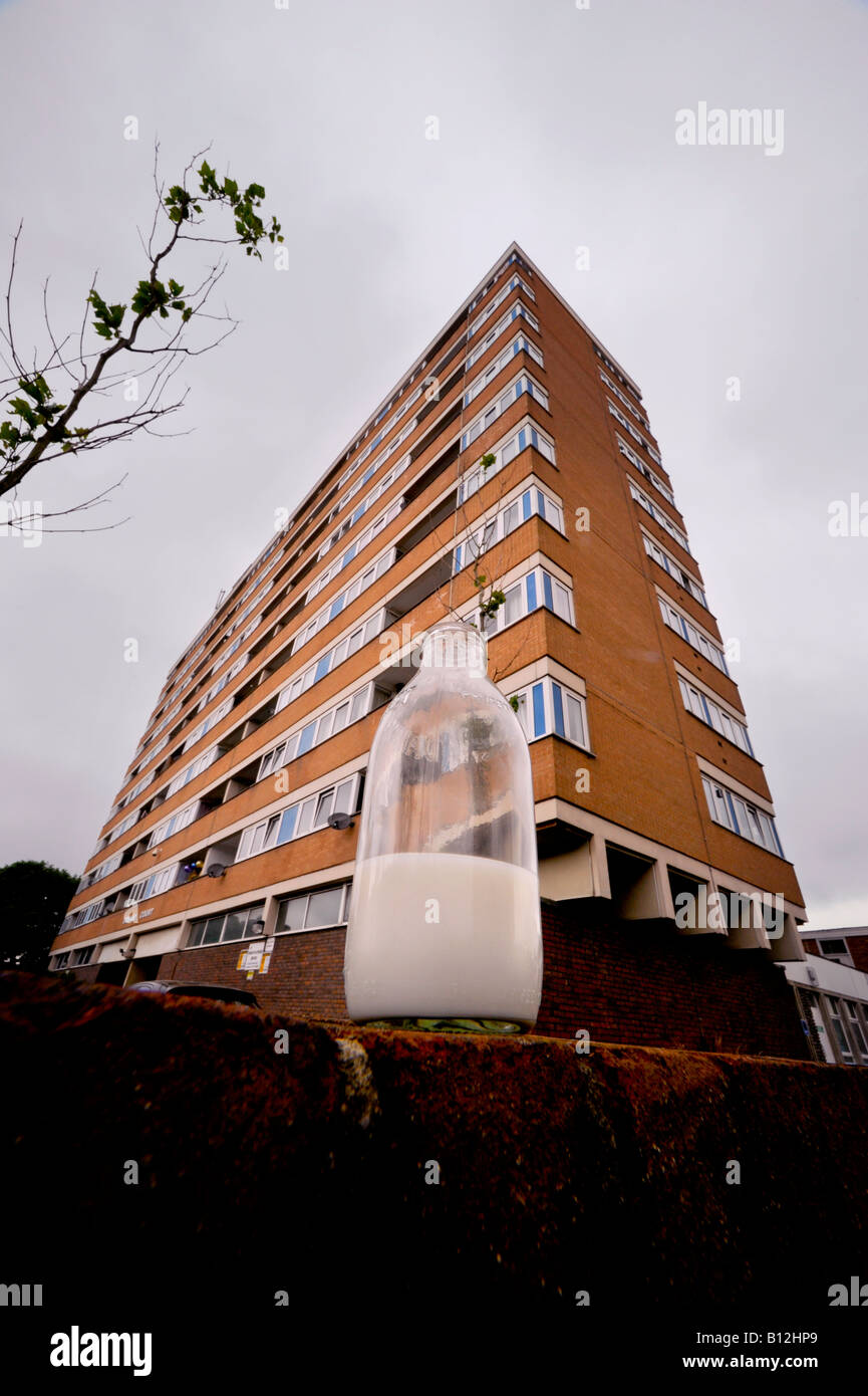 A partially drunk bottle of milk left on a wall outside a block of flats. Stock Photo