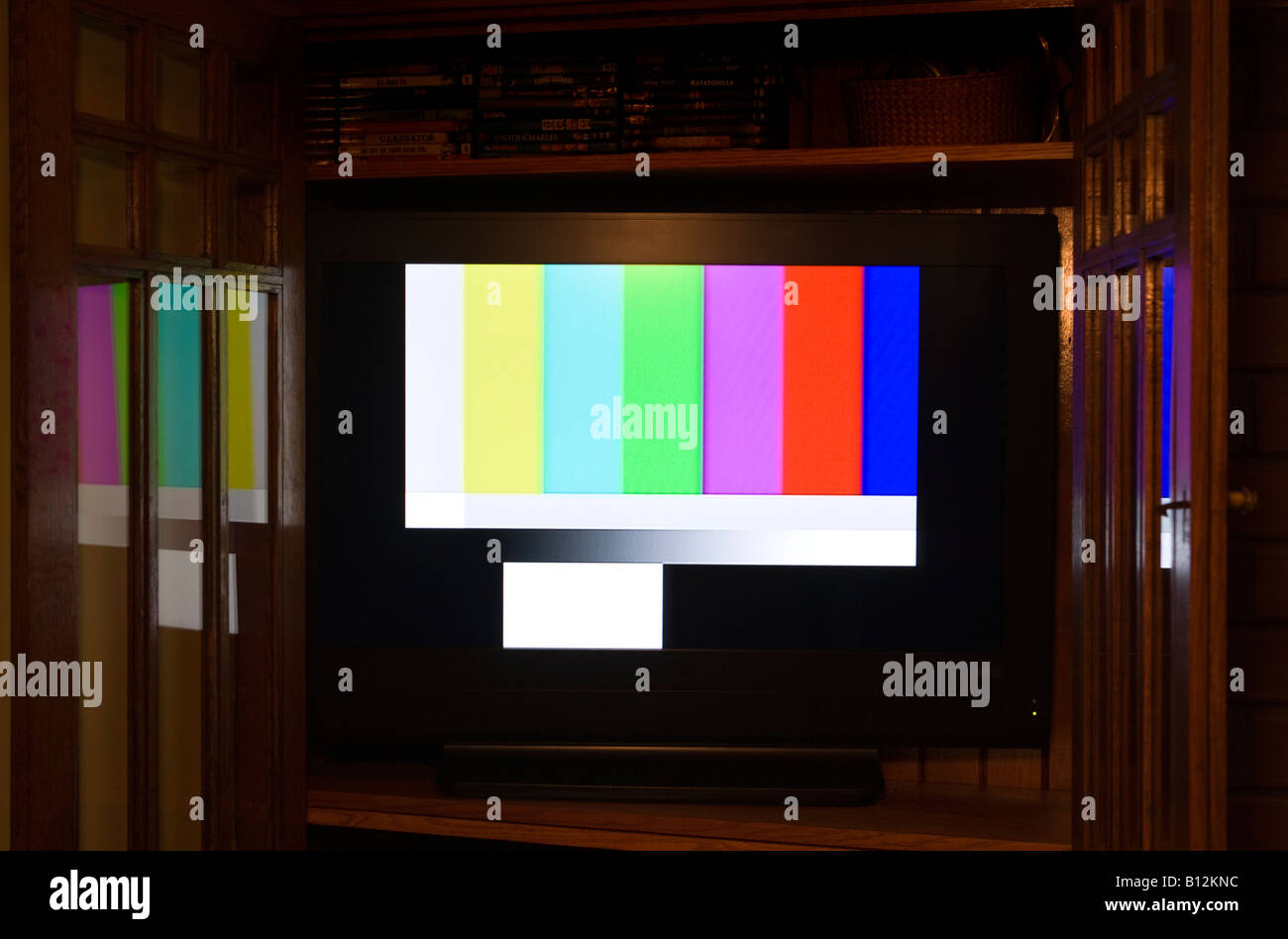 COLOR TEST CARD (© GEORGE HERSEE 1967) FLAT SCREEN TELEVISION (©SANYO CORP 2000) IN BUILT IN WOODEN CABINET. Stock Photo