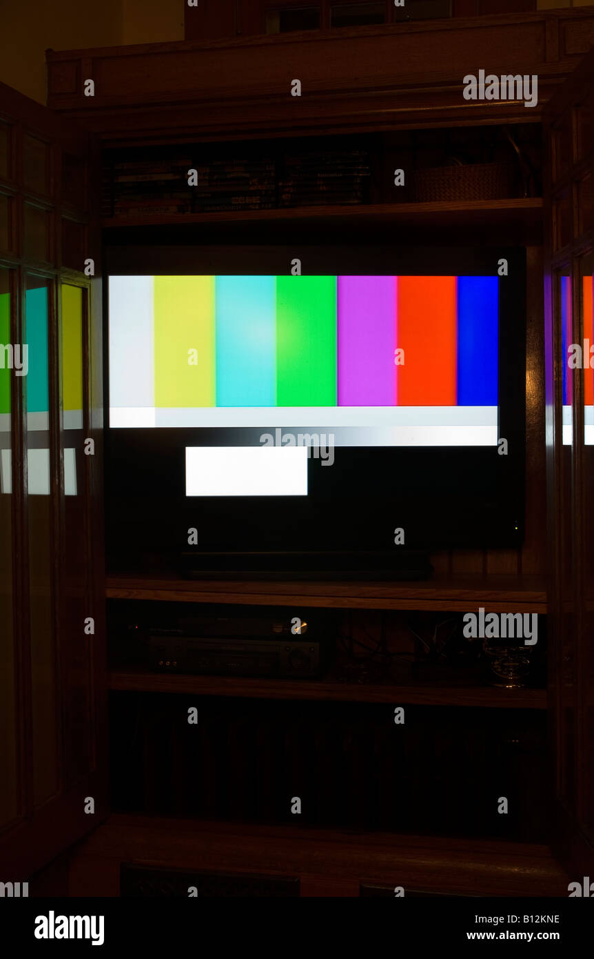 COLOR TEST CARD (© GEORGE HERSEE 1967) FLAT SCREEN TELEVISION (©SANYO CORP 2000) IN BUILT IN WOODEN CABINET. Stock Photo