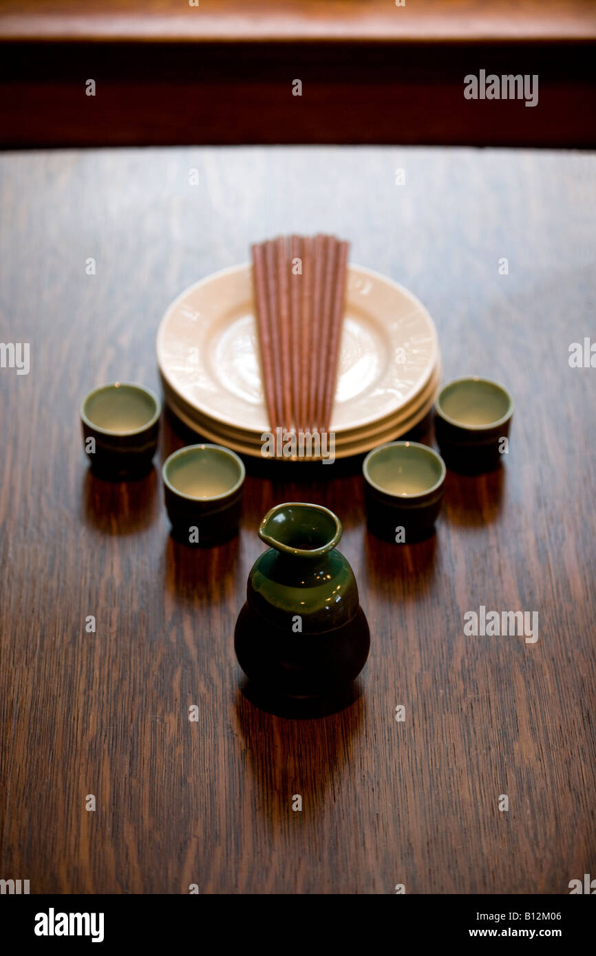 PORCELAIN SAKE PITCHER AND TUMBLERS ON OAK TABLE Stock Photo - Alamy