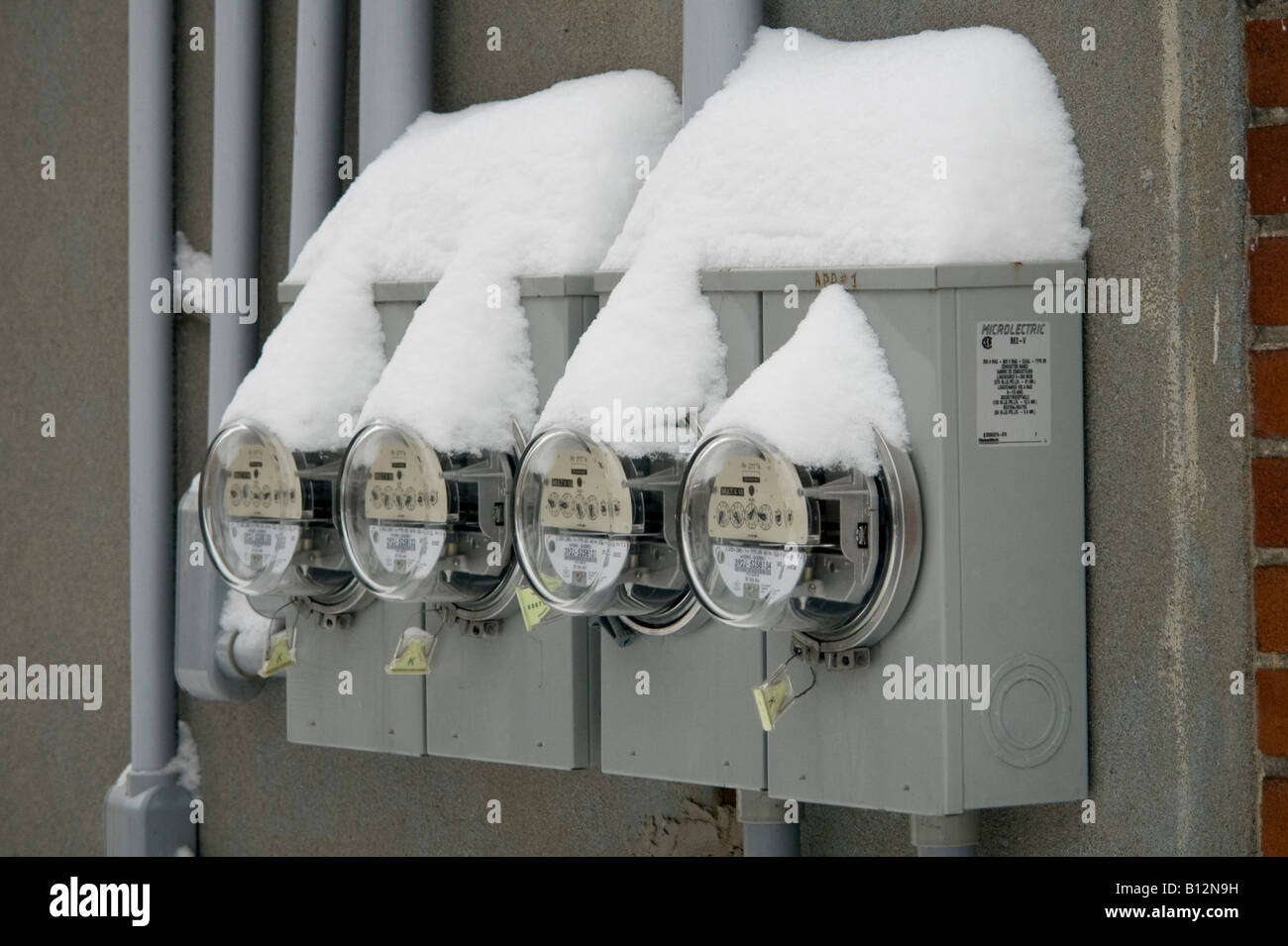 Electricity meters covered in fresh snow after a heavy snow storm in Montreal, Quebec, Canada. Stock Photo