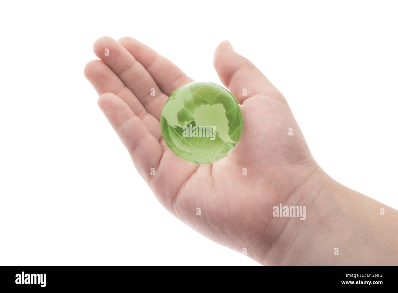 Green crystal globe in child's palm on white background Stock Photo