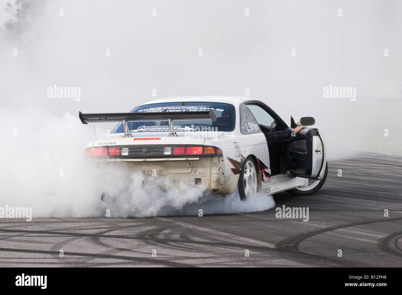 Australian Drift Motorsport competitor performs a celebration burnout in his modified Nissan 200SX after winning a Drift event Stock Photo