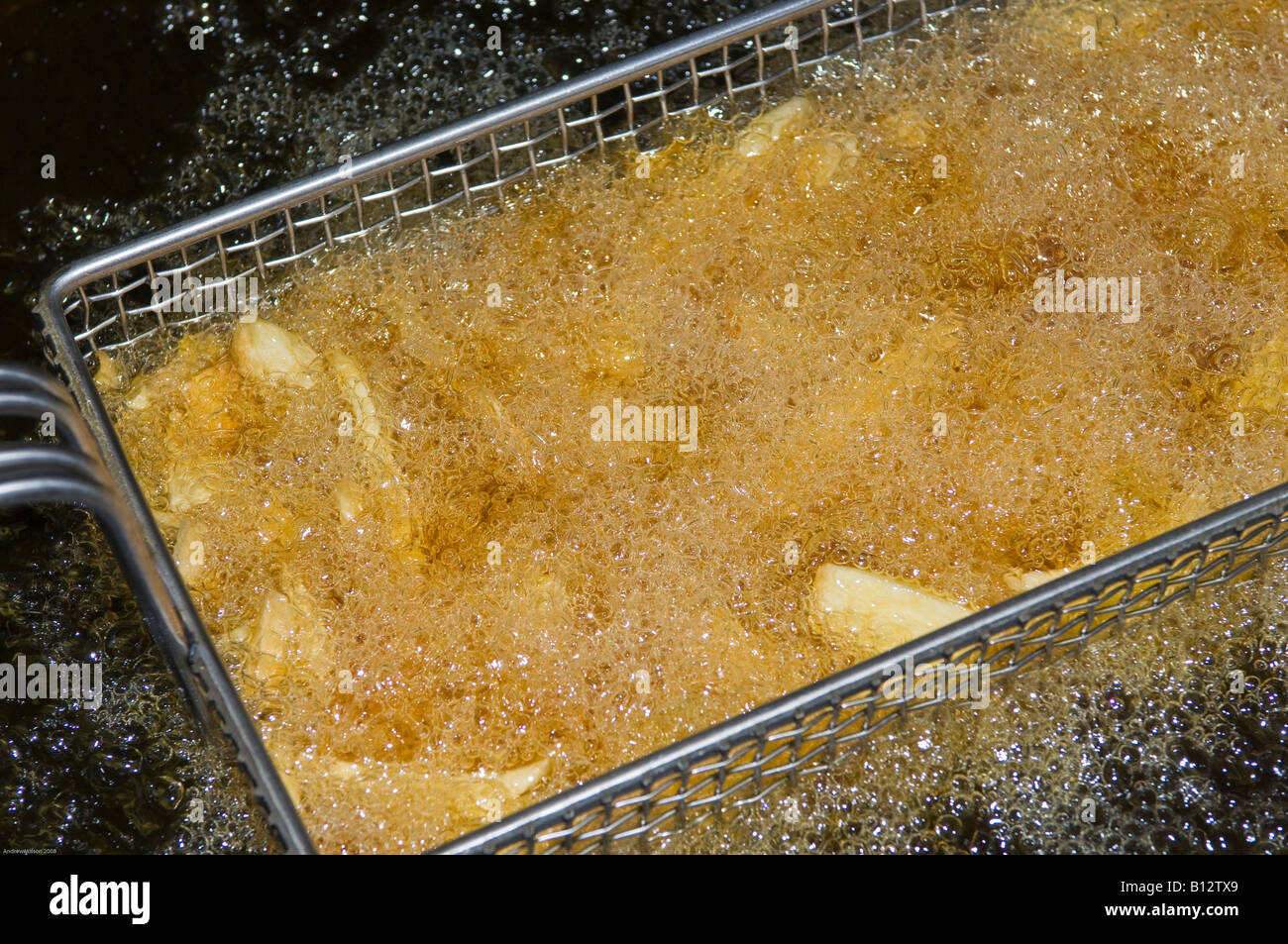 Chips in Deep Fat Fryer Stock Photo