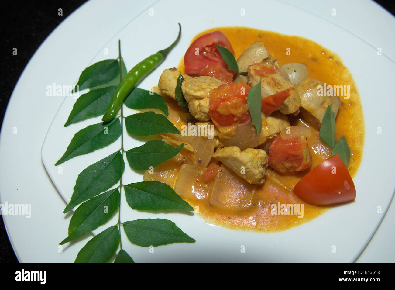 Plate of chicken curry Indian food with garnish ready to serve Stock Photo