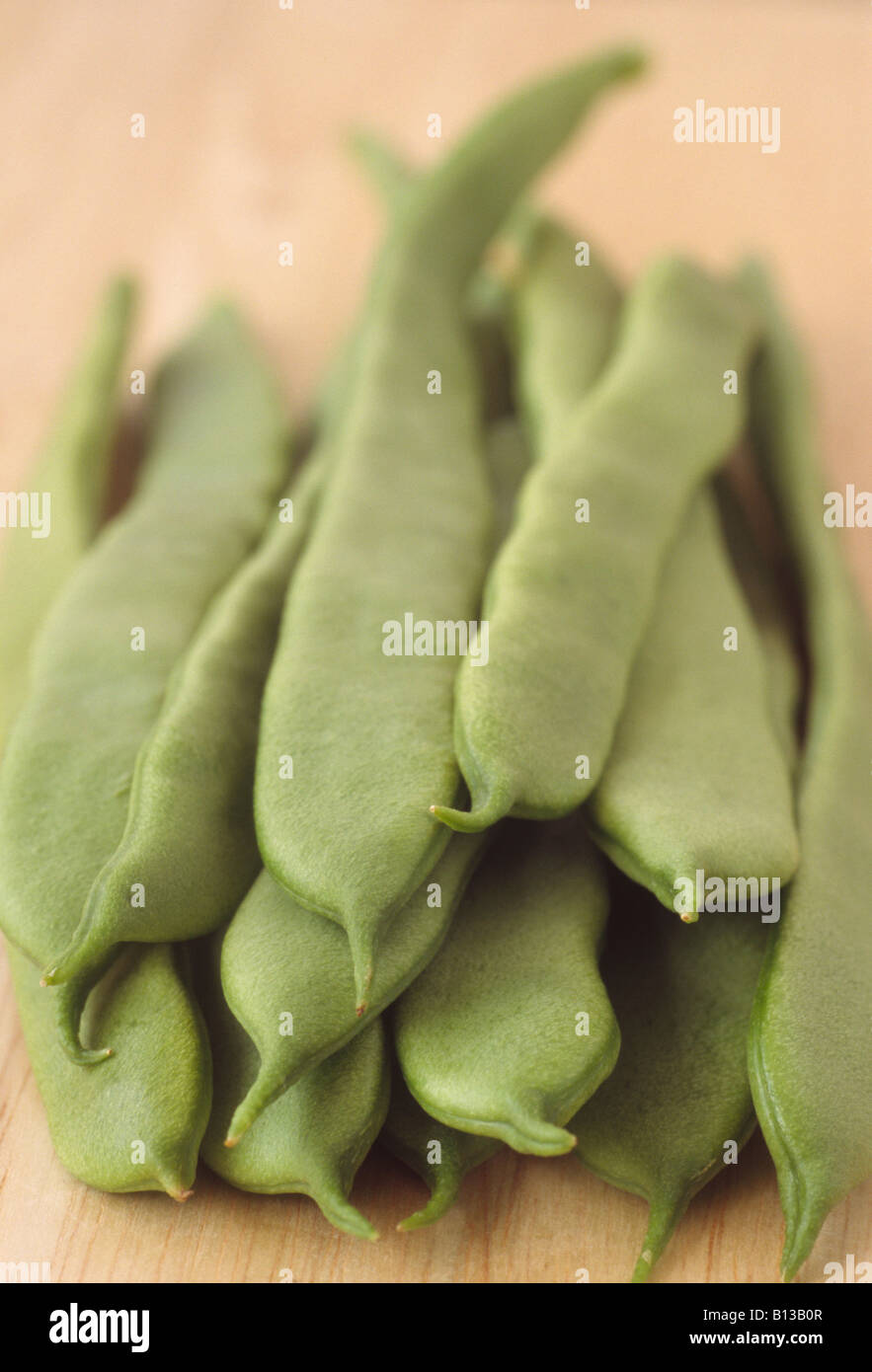 Phaseolus vulgaris 'Mantra' (Climbing French bean) Picked beans on a table. Stock Photo