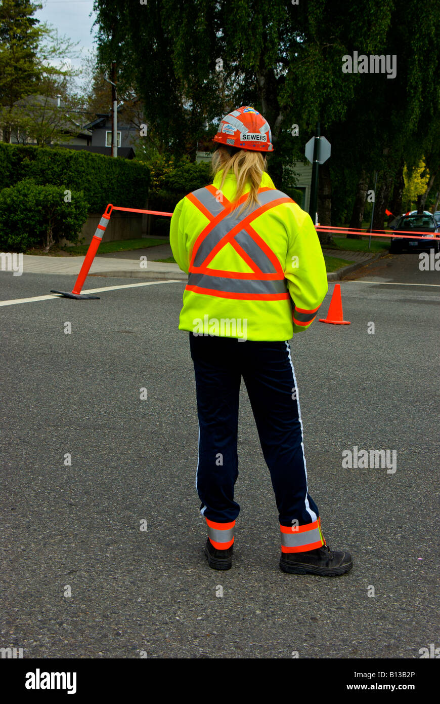 Traffic control person temporarily preventing drivers from entering an