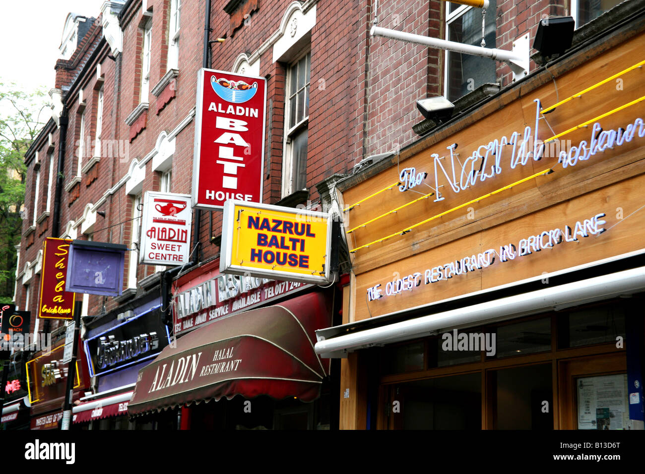 Signs on Indian restaurants in Brick Lane London Stock Photo