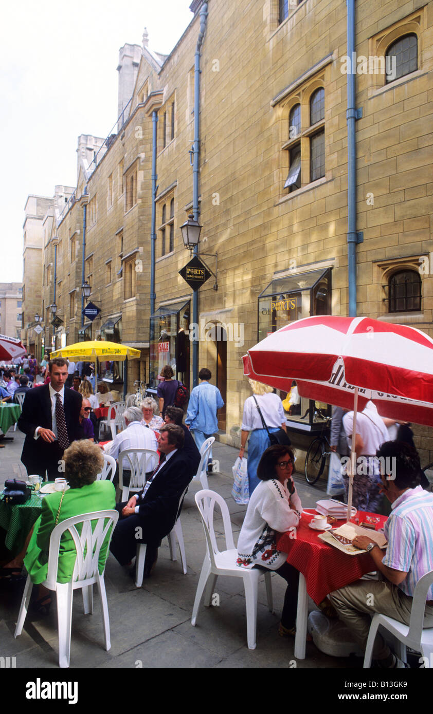 Cambridge street cafe Rose Crescent tables umbrellas sun shades sunshades people eating drinking pavement tables Cambridgeshire Stock Photo