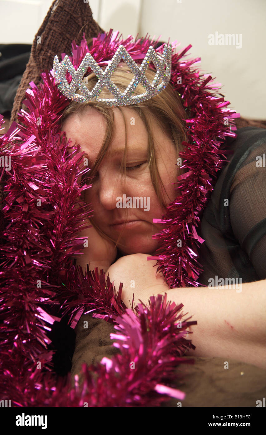 Older woman passed out on the sofa after partying Stock Photo