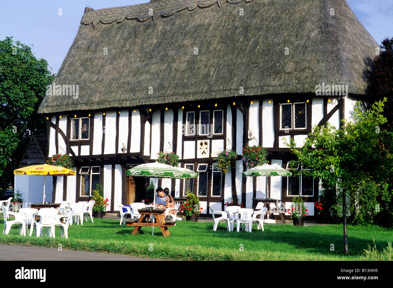 charming old thatched country pub Barrington Cambridgeshire Royal Oak East Anglia England UK timbered tables chairs couple Stock Photo