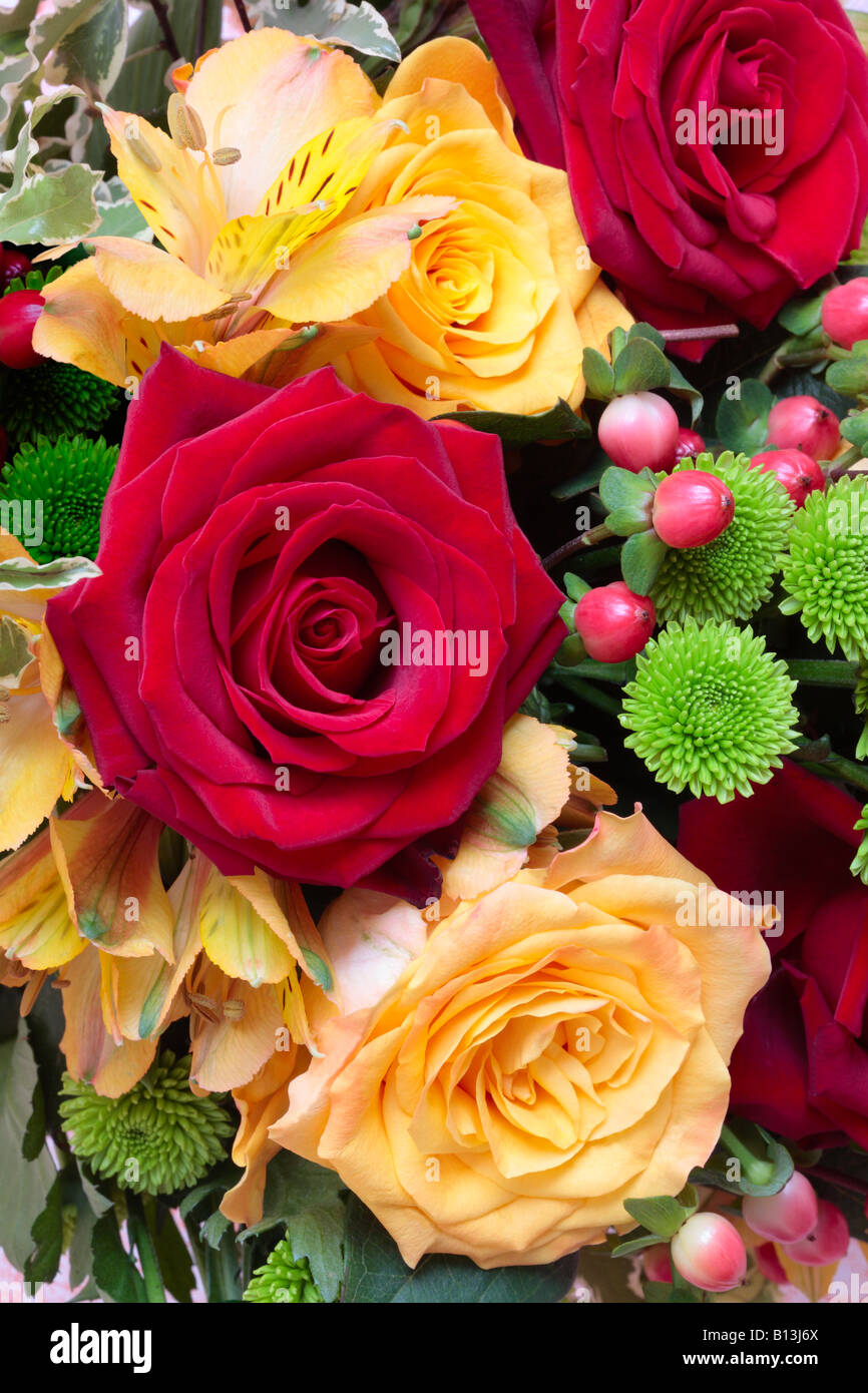Bunch of Flowers with Red Roses, Yellow Roses, Chrysanthemum, Hypericum and Peruvian Lily (Alstroemeria). Stock Photo