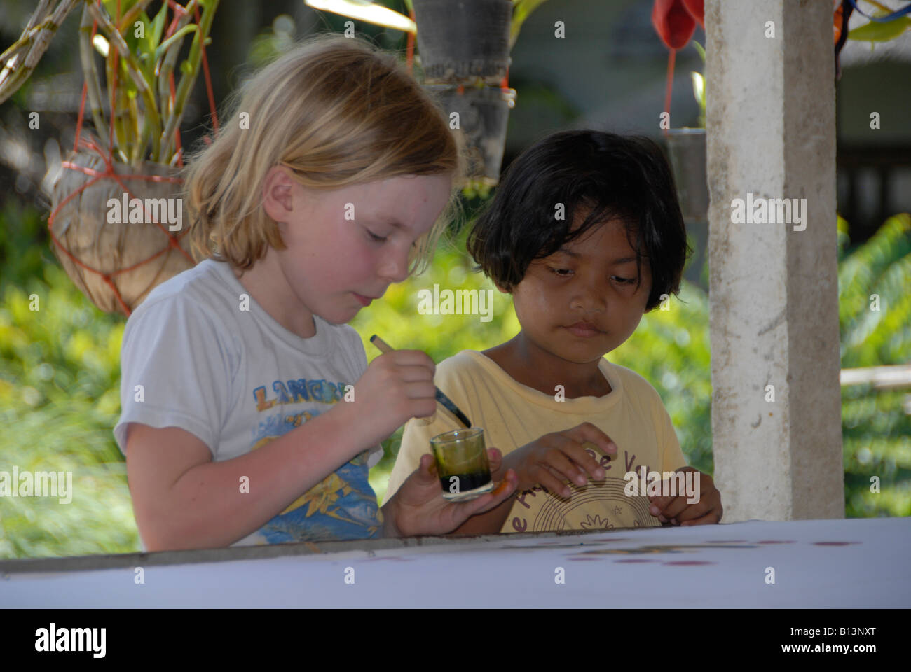 Lucy and Noon paint a batik in a village homestay in Thailand Stock Photo