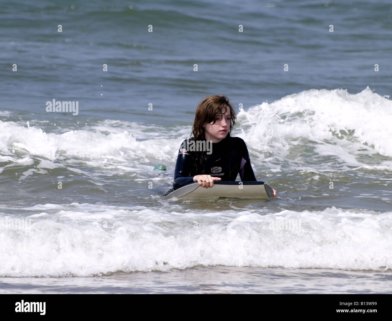 Teenage girl on a bodyboard in the sea. Cornwall, UK Stock Photo Alamy