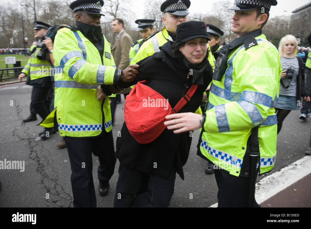 Police push a FitWatch demonstrator out of the way of the police pay