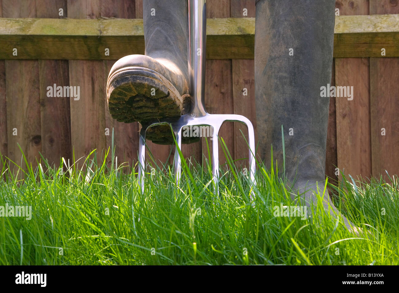 Gardening shot of a fork and wellington boots Stock Photo
