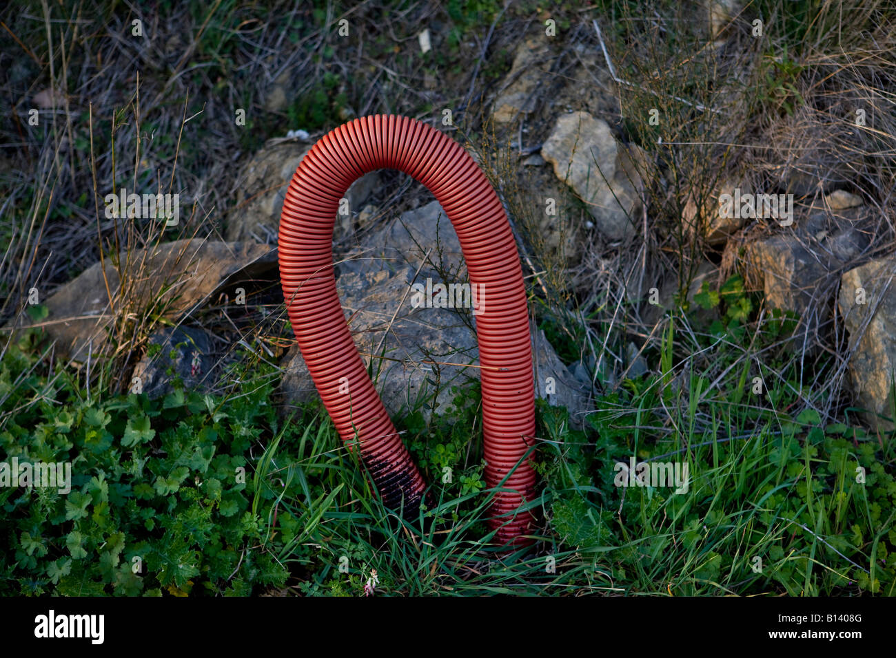 Red electricity cable being fitted in the Languedoc-Roussillon region of France Stock Photo
