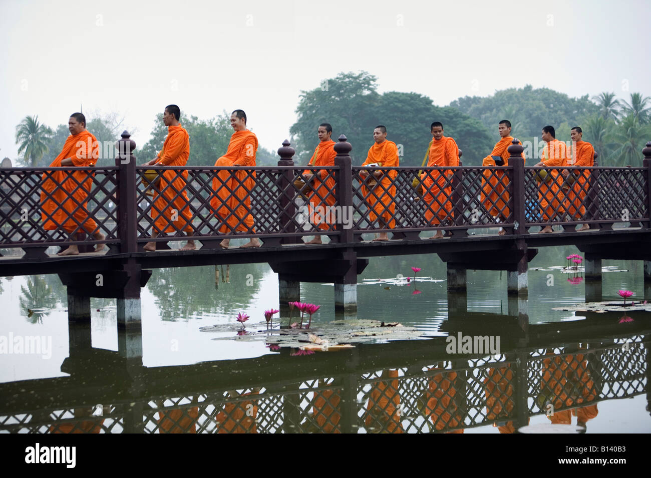 Monks crossing a bridge - Sukhothai, Sukhothai province, THAILAND Stock Photo