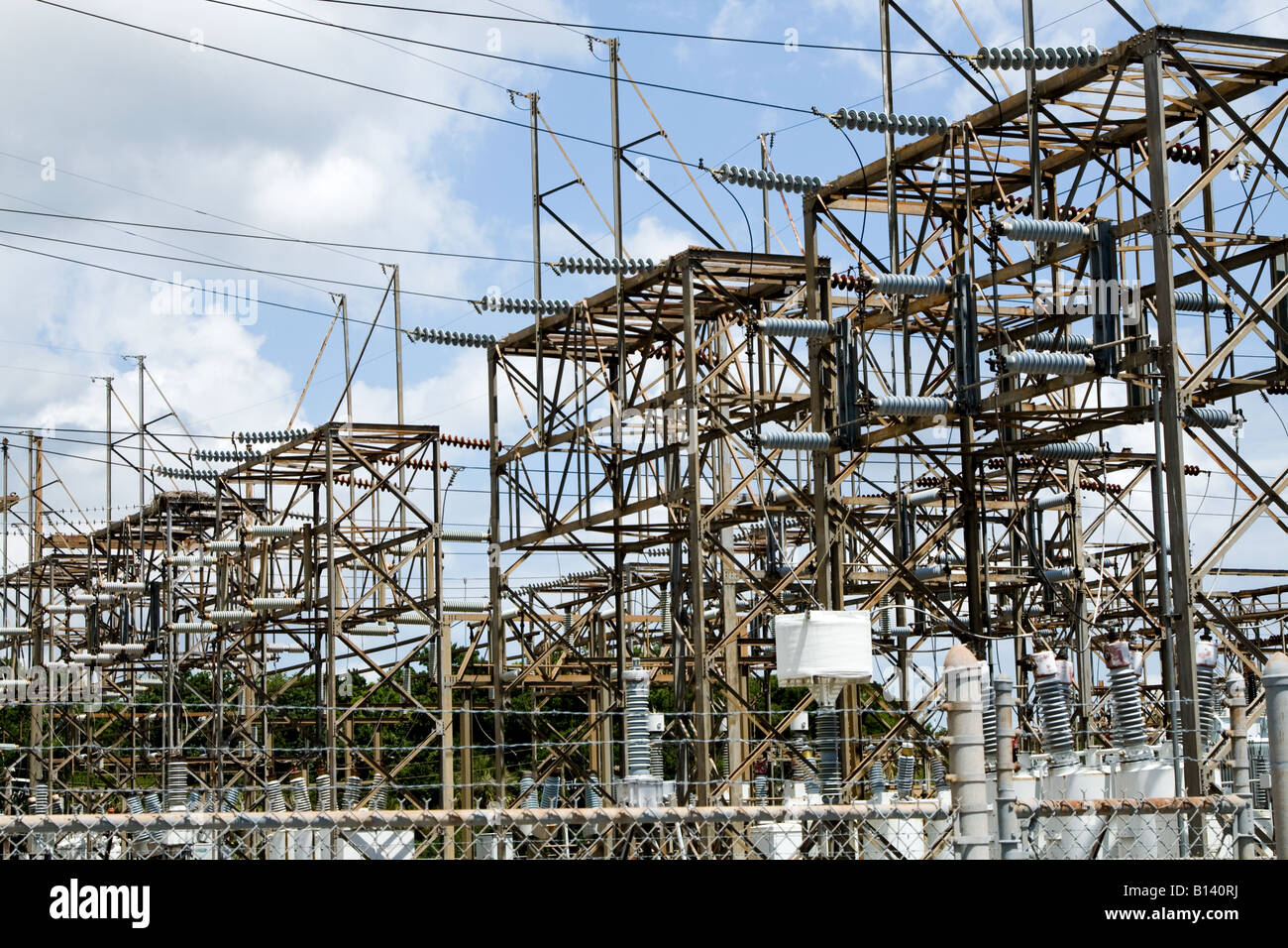 Metallic electric power grid and transformers behind a metal fence near